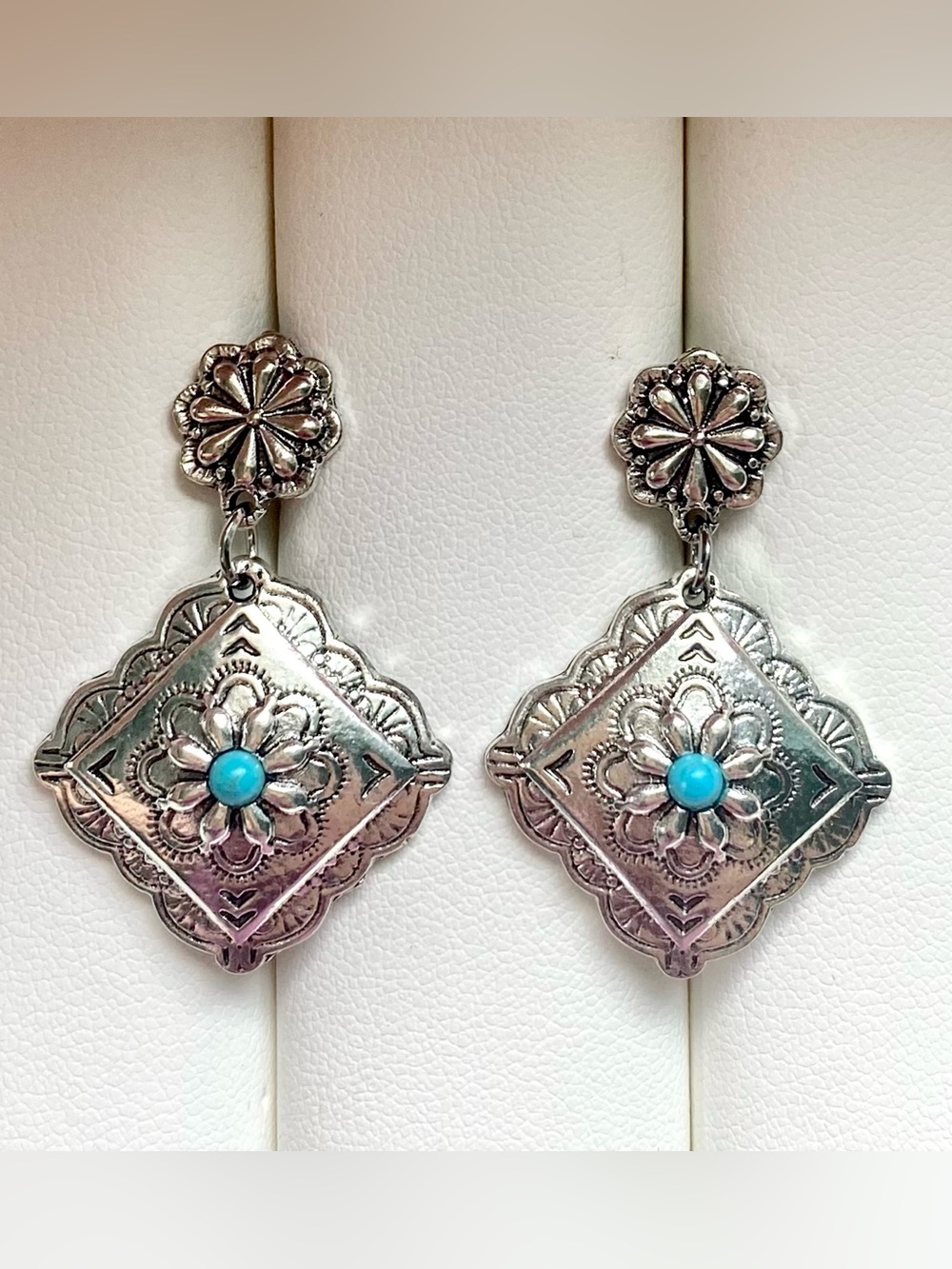 Silver and turquoise earrings with floral design